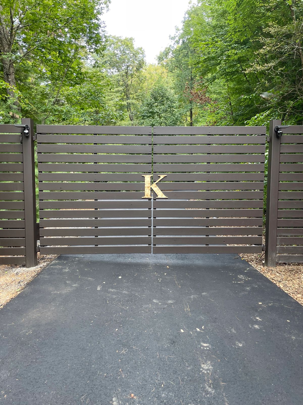Bronze horizontal-slat driveway gate