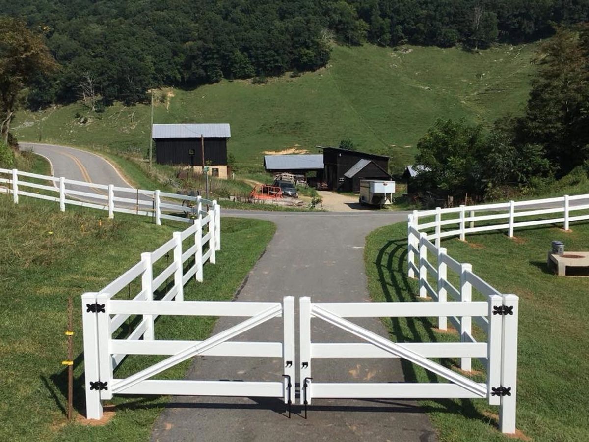 White vinyl three-rail double driveway gate